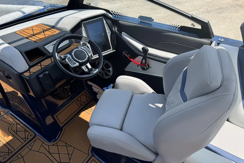 Slide: The Image of 2021 Tigé 23ZX boat interior with modern steering wheel and touchscreen display. - 8