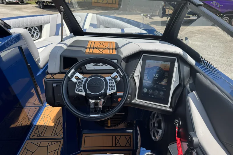 Slide: The Image of 2021 Tigé 23ZX boat interior with advanced touchscreen dashboard and steering wheel controls. - 9