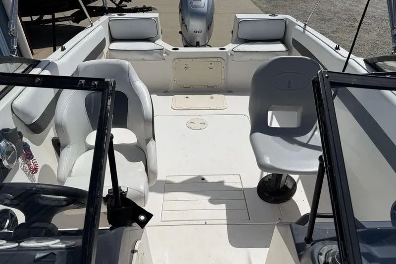Slide: The Image of 1994 Seaswirl 192 Striper boat interior with seating and steering console. - 10