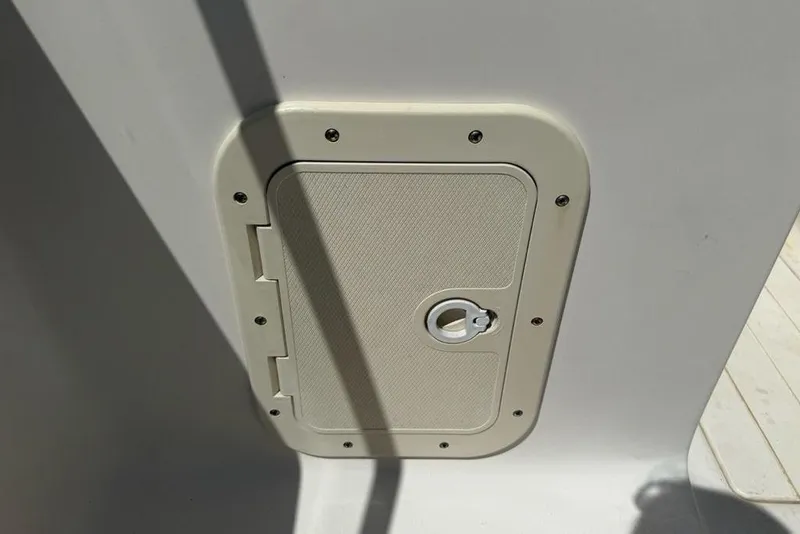 Slide: The Image of Access hatch on 1994 Seaswirl 192 Striper boat, secured with screws. - 16