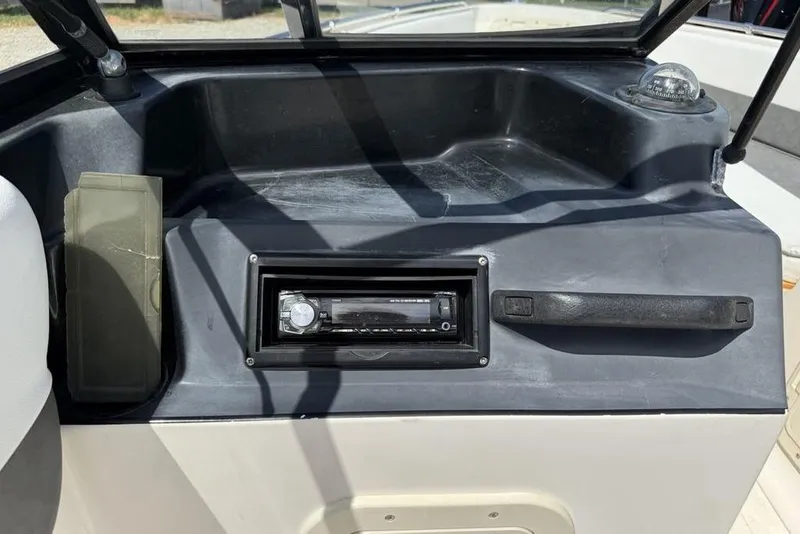 Slide: The Image of 1994 Seaswirl 192 Striper boat dashboard with stereo and compass. - 19