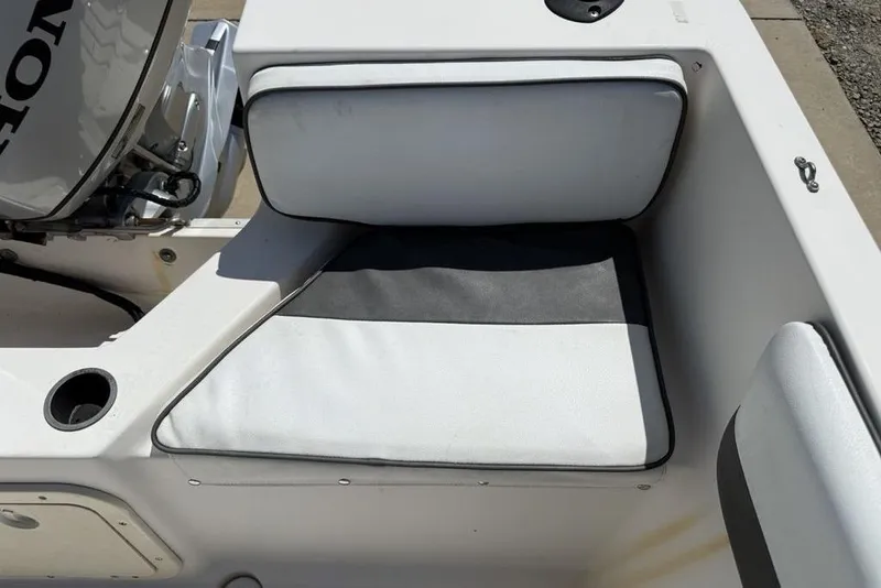 Slide: The Image of 1994 Seaswirl 192 Striper boat interior with cushioned seating and motor detail. - 24