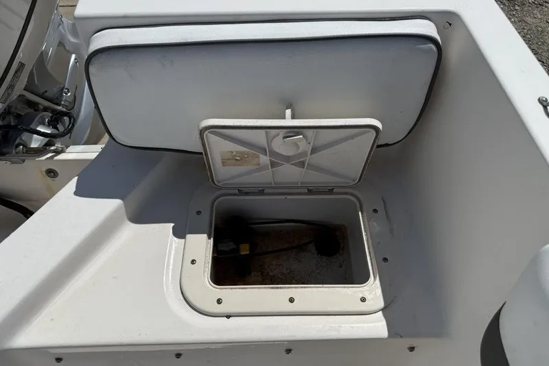 Slide: The Image of Open storage compartment on a 1994 Seaswirl 192 Striper boat, showing interior details. - 26