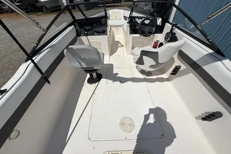 Slide: The Image of 1994 Seaswirl 192 Striper boat interior with seating and steering wheel. - 28