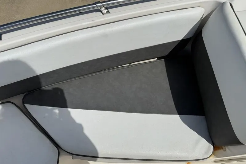 Slide: The Image of Interior seating of 1994 Seaswirl 192 Striper boat, featuring gray and white upholstery. - 4