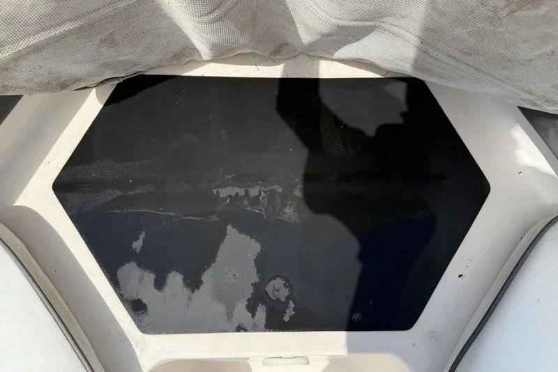 Slide: The Image of 1994 Seaswirl 192 Striper boat interior with black hexagonal panel and fabric cover. - 5