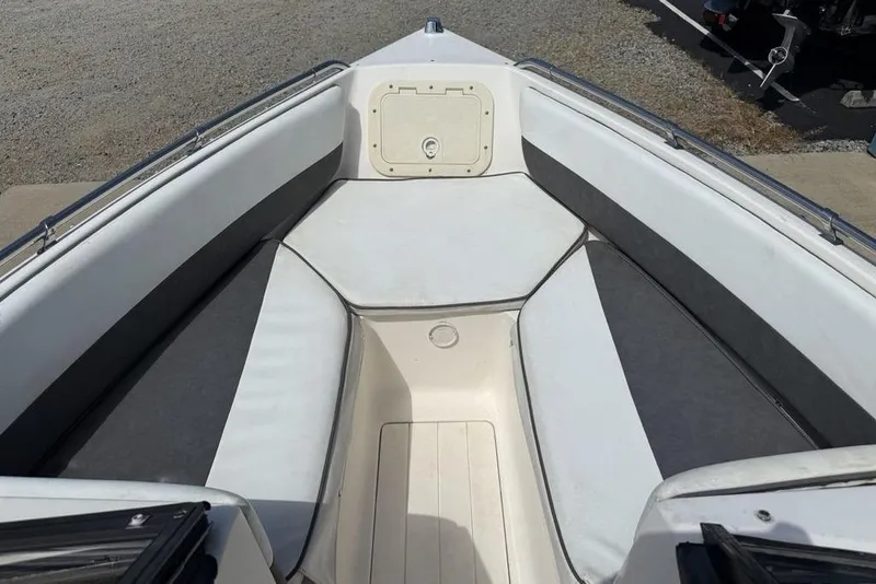 Slide: The Image of 1994 Seaswirl 192 Striper boat interior with cushioned seating and storage compartment. - 6