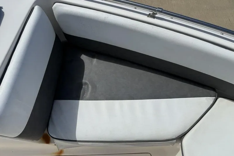 Slide: The Image of 1994 Seaswirl 192 Striper boat interior seating with white and gray upholstery. - 7