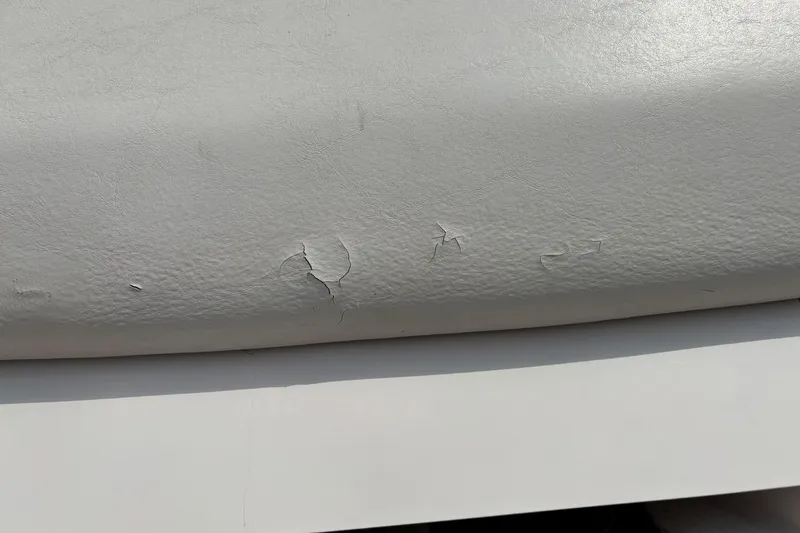 Slide: The Image of Cracked upholstery on 1999 MasterCraft 205 PRO STAR boat seat. - 14