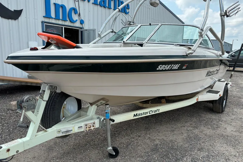 Slide: The Image of 1999 MasterCraft 205 PRO STAR boat on trailer, parked outside a building. - 4