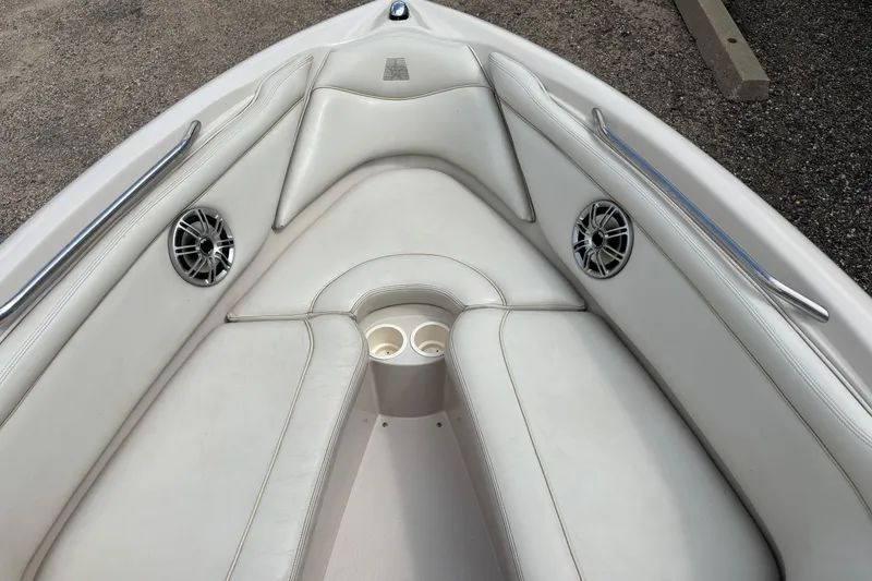 Slide: The Image of 1999 MasterCraft 205 PRO STAR boat interior with white seating and speakers. - 12