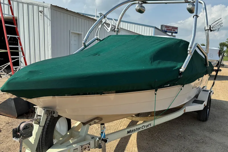 Slide: The Image of 1999 MasterCraft 205 PRO STAR boat with green cover on trailer. - 18