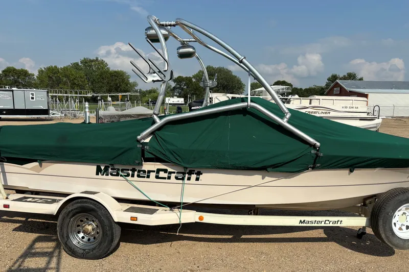 Slide: The Image of 1999 MasterCraft 205 PRO STAR boat with green cover on trailer. - 19