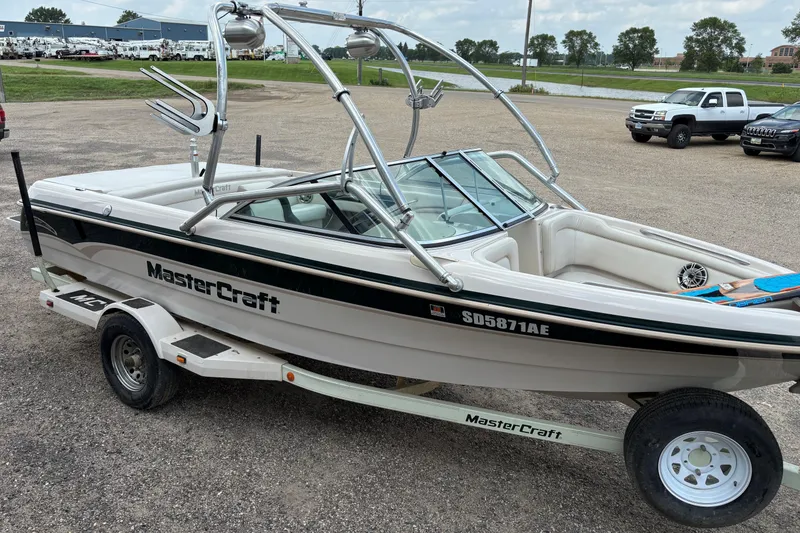 Slide: The Image of 1999 MasterCraft 205 PRO STAR boat on trailer, parked outdoors. - 3