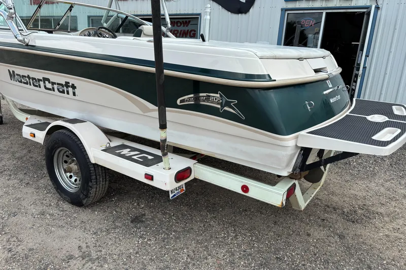 Slide: The Image of 1999 MasterCraft 205 PRO STAR boat on trailer, parked outside a building. - 5