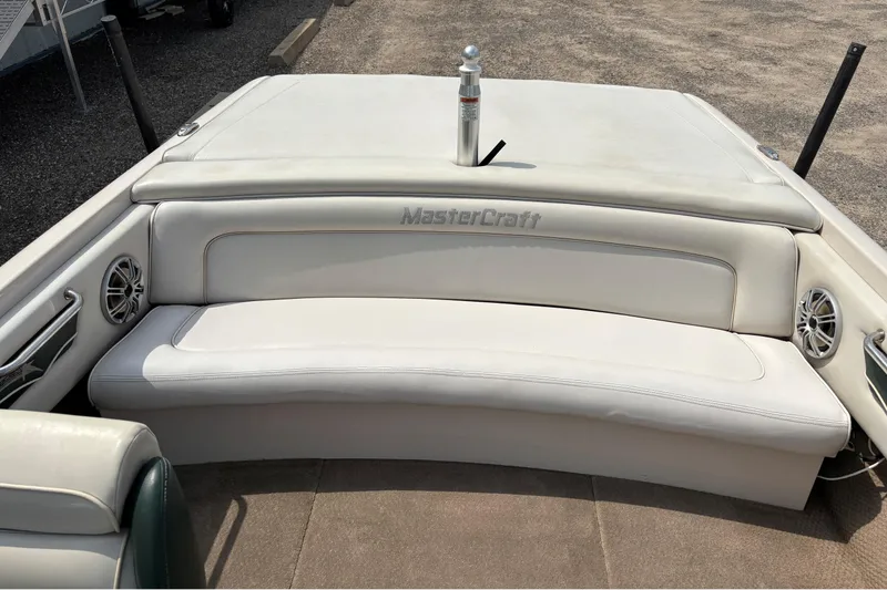 Slide: The Image of 1999 MasterCraft 205 PRO STAR boat interior with white seating and branded upholstery. - 9