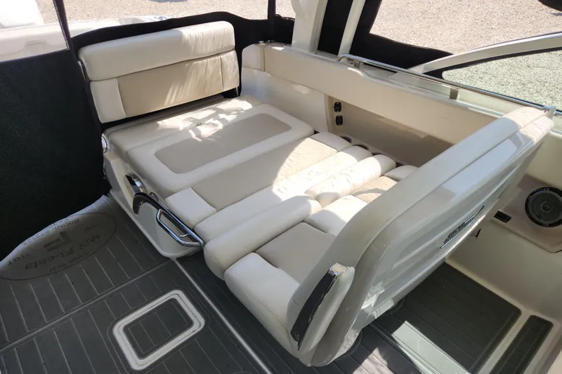 Slide: The Image of 2018 Boston Whaler 320 Vantage interior seating, featuring luxurious cream upholstery and sleek design. - 10