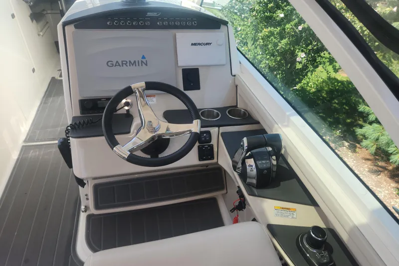 Slide: The Image of 2018 Boston Whaler 320 Vantage helm with Garmin navigation and Mercury controls. - 14