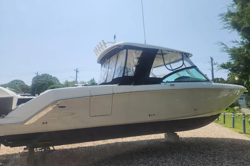 Slide: The Image of 2018 Boston Whaler 320 Vantage boat displayed outdoors on gravel. - 2