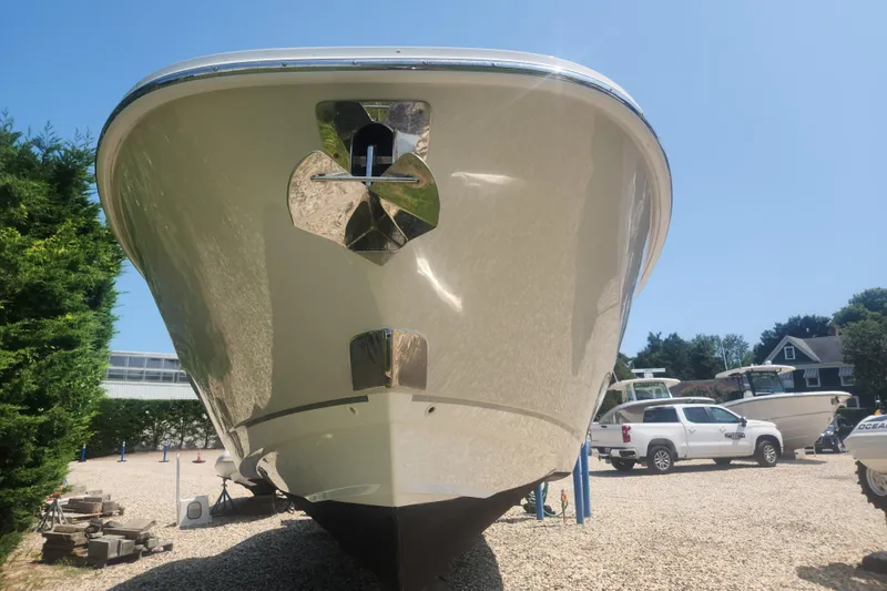 Slide: The Image of 2018 Boston Whaler 320 Vantage boat on gravel lot, front view. - 20