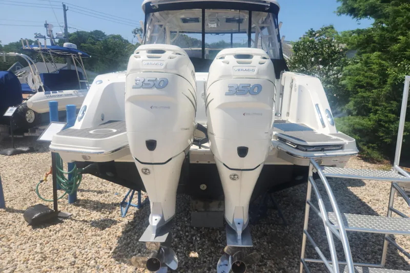 Slide: The Image of 2018 Boston Whaler 320 Vantage with twin 350 Verado engines, docked outdoors. - 3