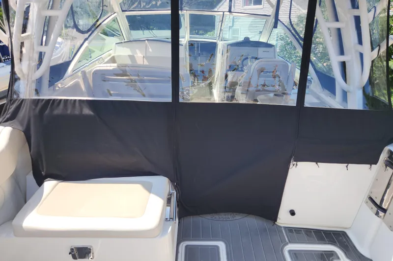Slide: The Image of 2018 Boston Whaler 320 Vantage boat interior with protective cover and seating area. - 7