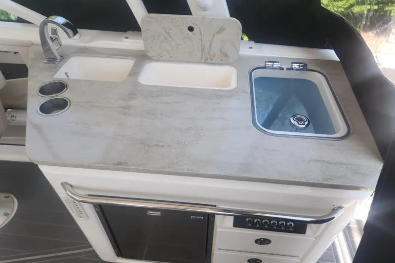 Slide: The Image of 2018 Boston Whaler 320 Vantage boat kitchenette with sink and countertop. - 8
