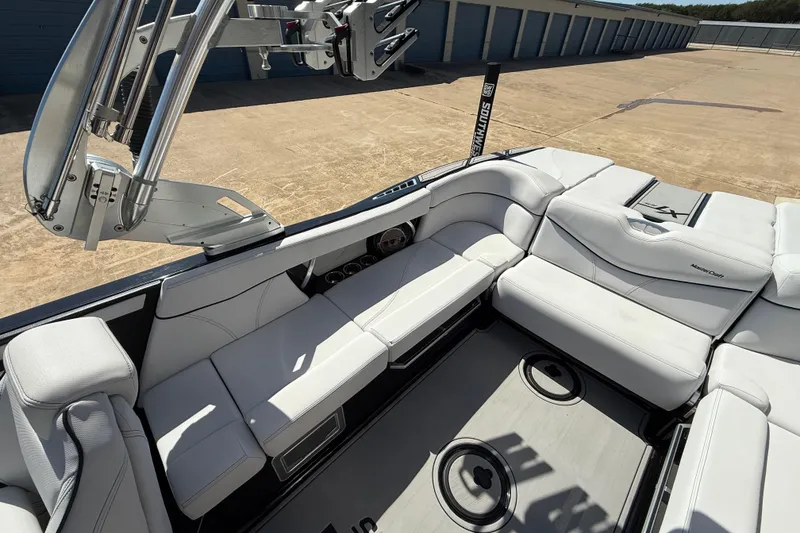 Slide: The Image of 2020 MasterCraft XT25 boat interior with white seating and sleek design. - 10