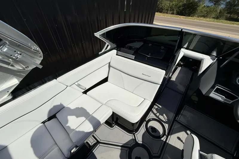 Slide: The Image of 2020 MasterCraft XT25 boat interior with white seating and modern design. - 12