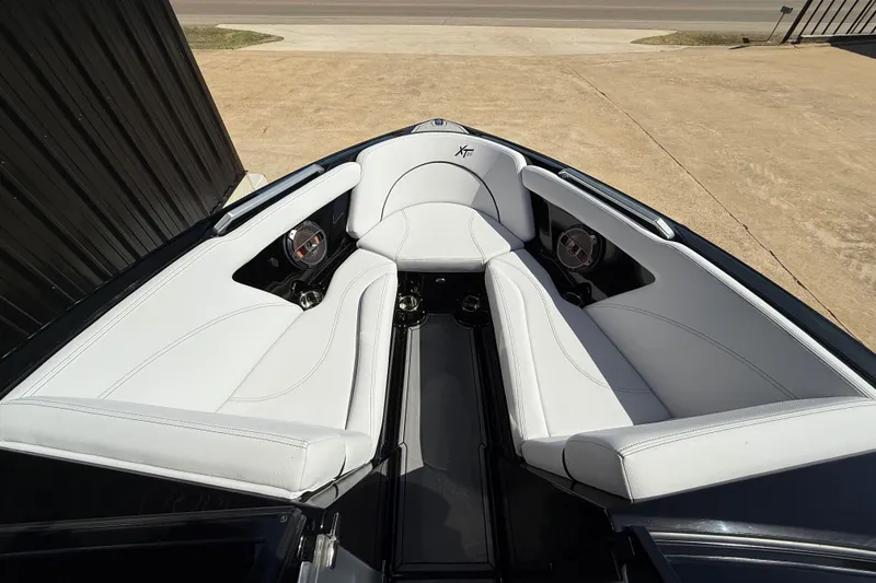 Slide: The Image of 2020 MasterCraft XT25 boat interior with white seating and speakers. - 13