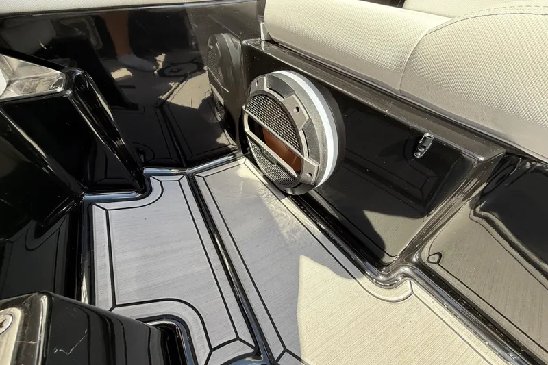 Slide: The Image of 2020 MasterCraft XT25 boat interior with speaker and sleek flooring design. - 16