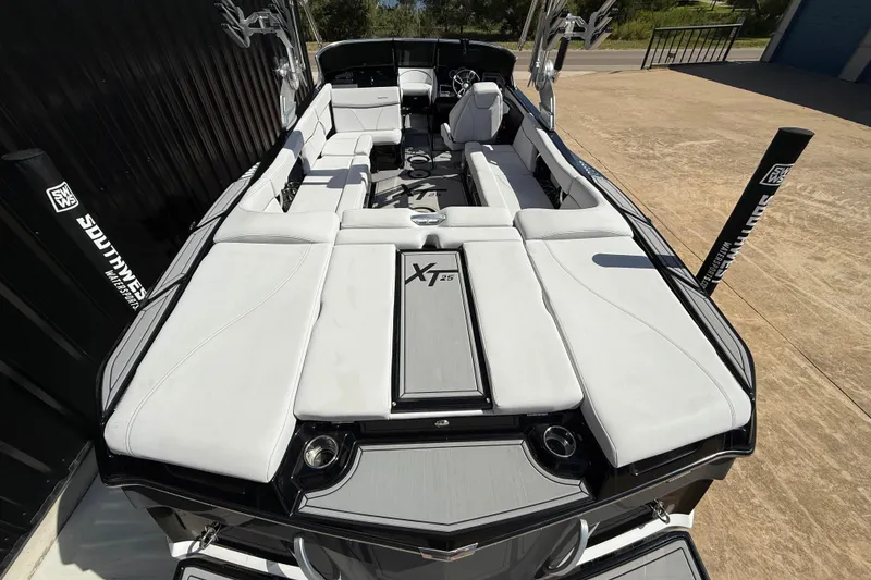 Slide: The Image of 2020 MasterCraft XT25 boat with sleek white seating and modern design. - 7
