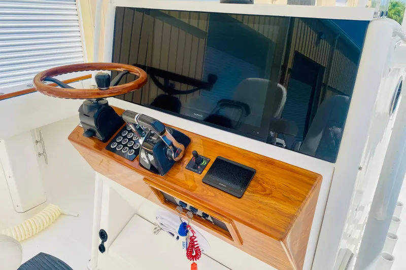 The Image of 2005 Venture 39 Open boat helm with faux teak steering wheel and dash, featuring the new 24" Garmin screen - 0