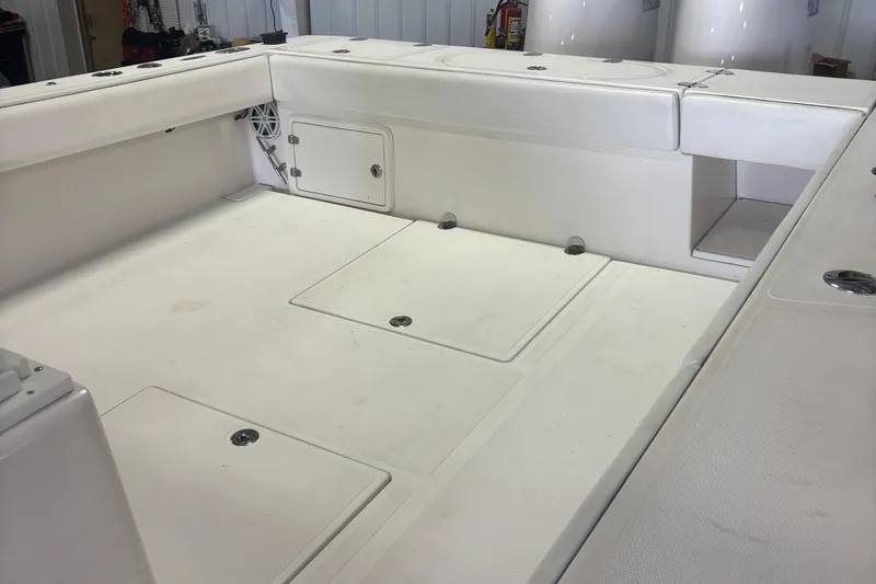 Slide: The Image of 2005 Venture boat interior with storage compartments and clean white deck. - 24