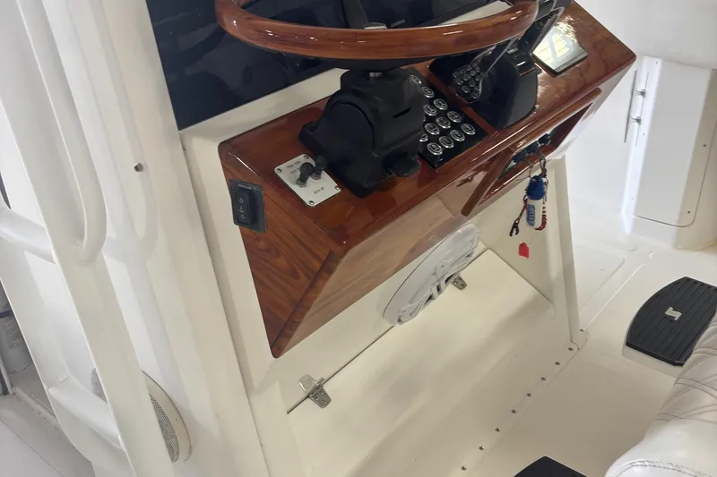Slide: The Image of 2005 Venture boat helm with wooden steering wheel and control panel. - 25