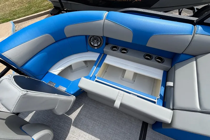 Slide: The Image of Interior of 2025 Montara 25 Surf Boss boat with blue and gray seating. - 16