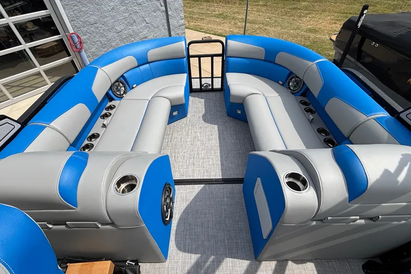 Slide: The Image of 2025 Montara 25 Surf Boss boat interior with blue and gray seating and cup holders. - 19