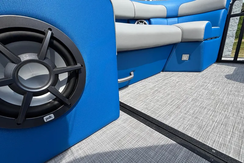 Slide: The Image of 2025 Montara 25 Surf Boss interior with blue seating and Polk audio speaker. - 26