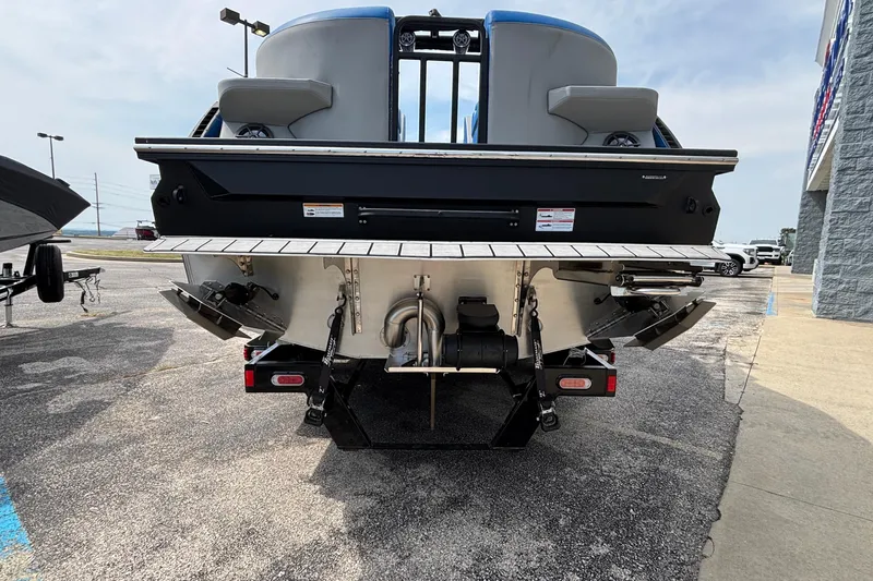 Slide: The Image of 2025 Montara 25 Surf Boss boat rear view in a parking lot. - 30