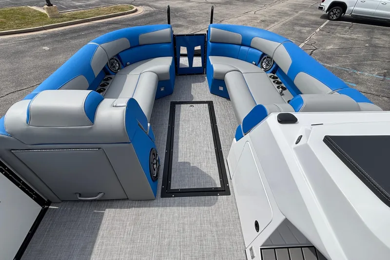 Slide: The Image of 2025 Montara 25 Surf Boss boat interior with blue and gray seating, spacious layout. - 6