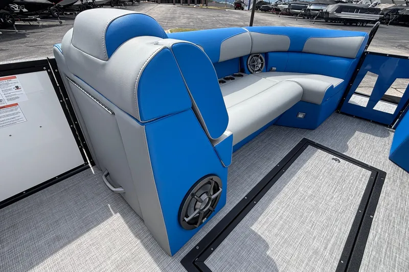 Slide: The Image of 2025 Montara 25 Surf Boss interior with blue and gray seating, speakers, and cup holders. - 7