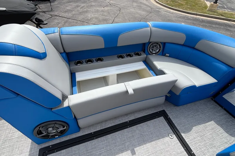 Slide: The Image of 2025 Montara 25 Surf Boss boat interior with blue and gray seating, storage, and speakers. - 9