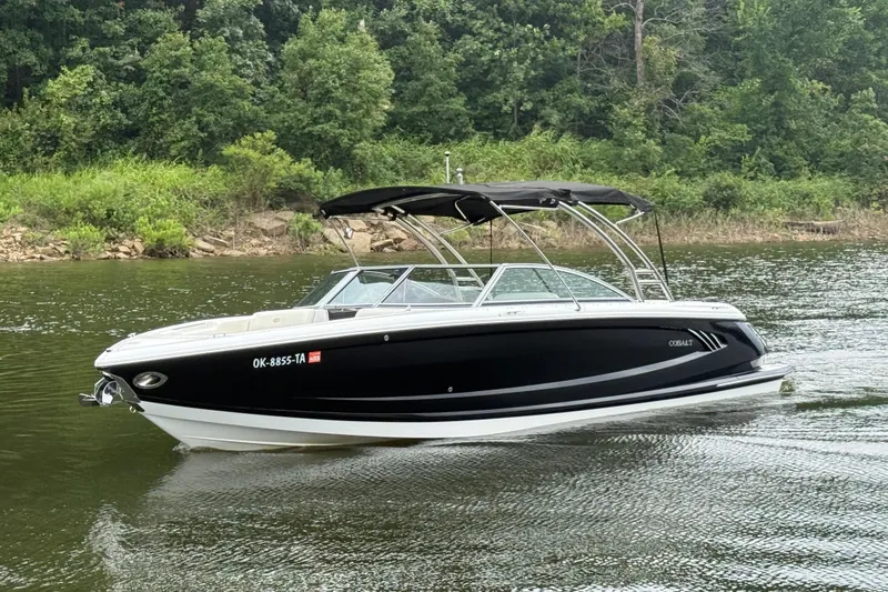 Slide: The Image of 2013 Cobalt A28 boat on a calm lake with lush green background. - 10