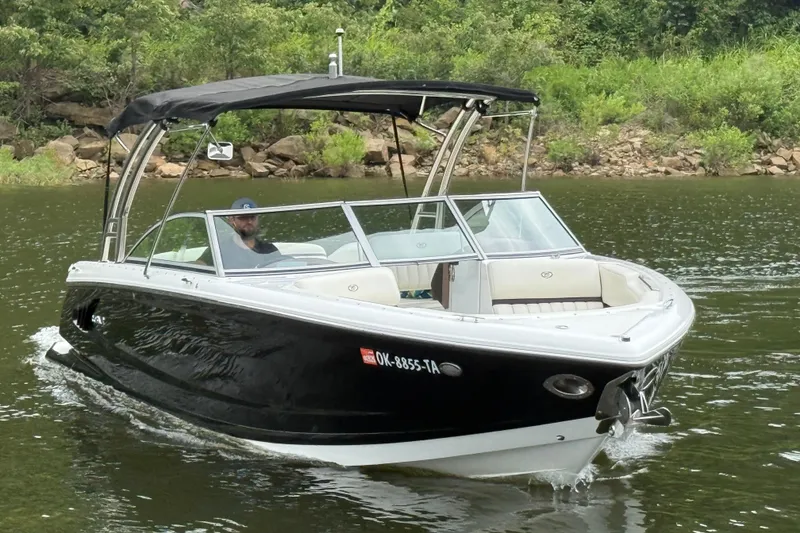 Slide: The Image of 2013 Cobalt A28 boat cruising on a scenic river with lush greenery. - 16