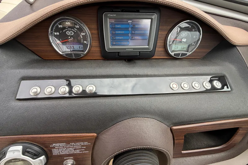 Slide: The Image of Dashboard of a 2013 Cobalt A28 boat with gauges and Garmin display. - 22