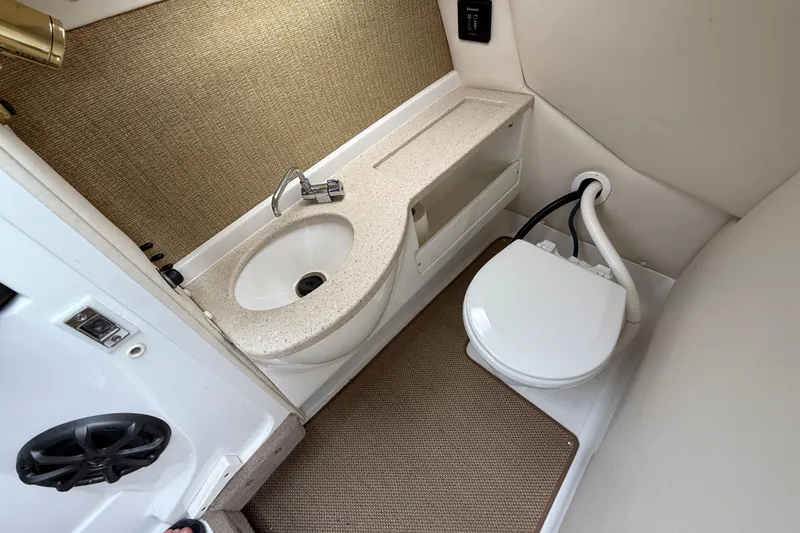 Slide: The Image of 2013 Cobalt A28 boat bathroom with sink and toilet, compact and functional design. - 25