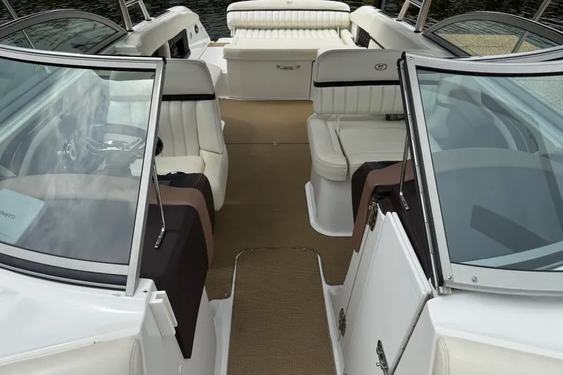 Slide: The Image of 2013 Cobalt A28 boat interior with white seating and open cockpit design. - 27