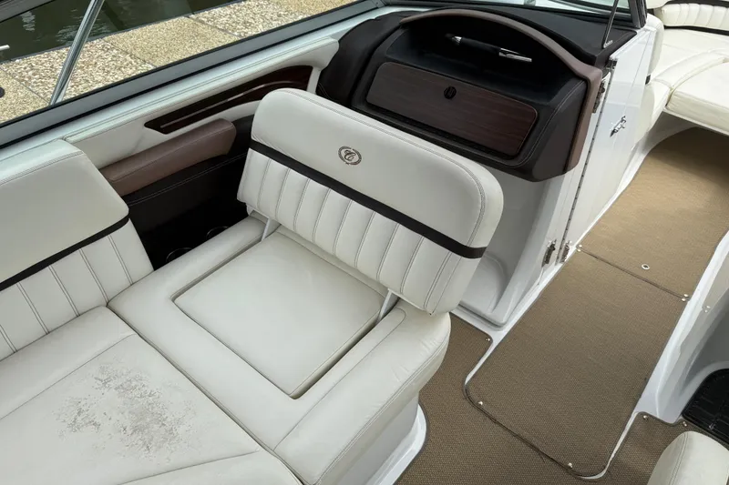 Slide: The Image of 2013 Cobalt A28 boat interior with white leather seating and brown accents. - 28