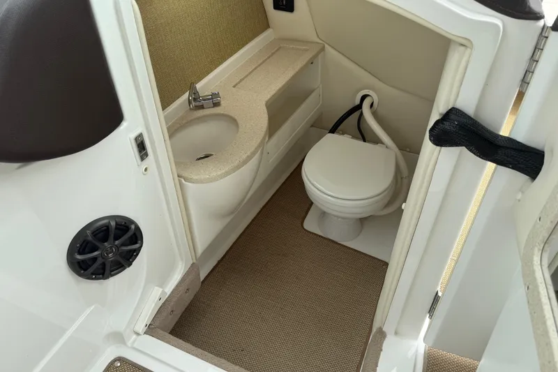 Slide: The Image of 2013 Cobalt A28 boat bathroom with sink, toilet, and speaker. - 29