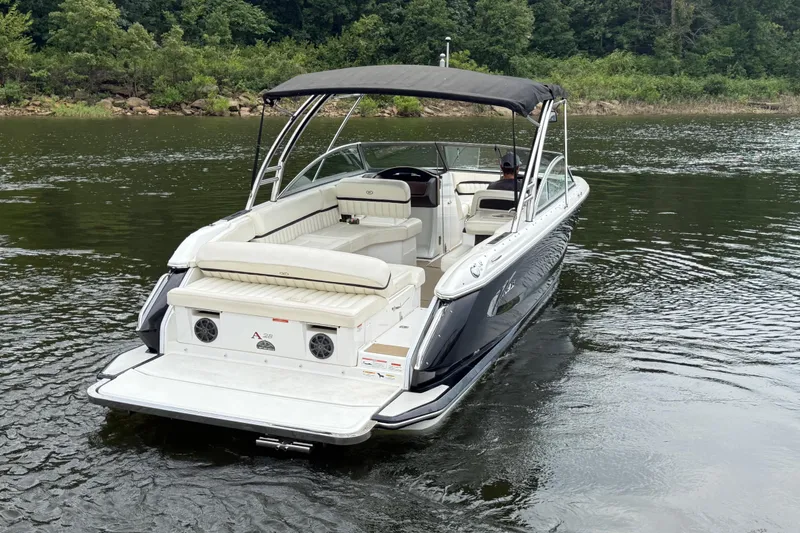 Slide: The Image of 2013 Cobalt A28 boat with canopy cruising on a calm lake. - 3